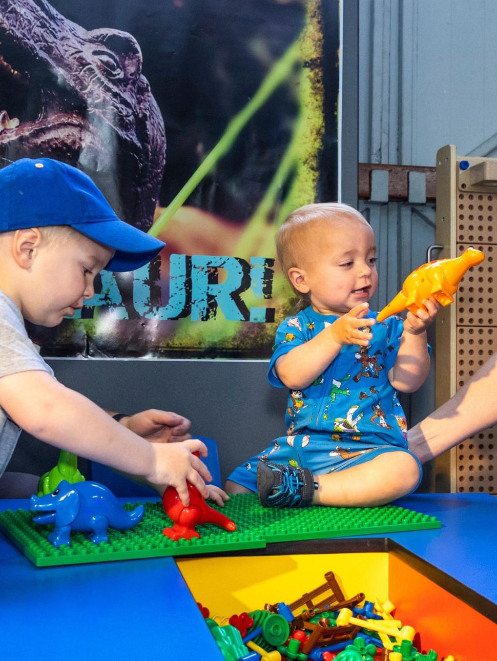 Image of children playing with plastic dinosaurs 