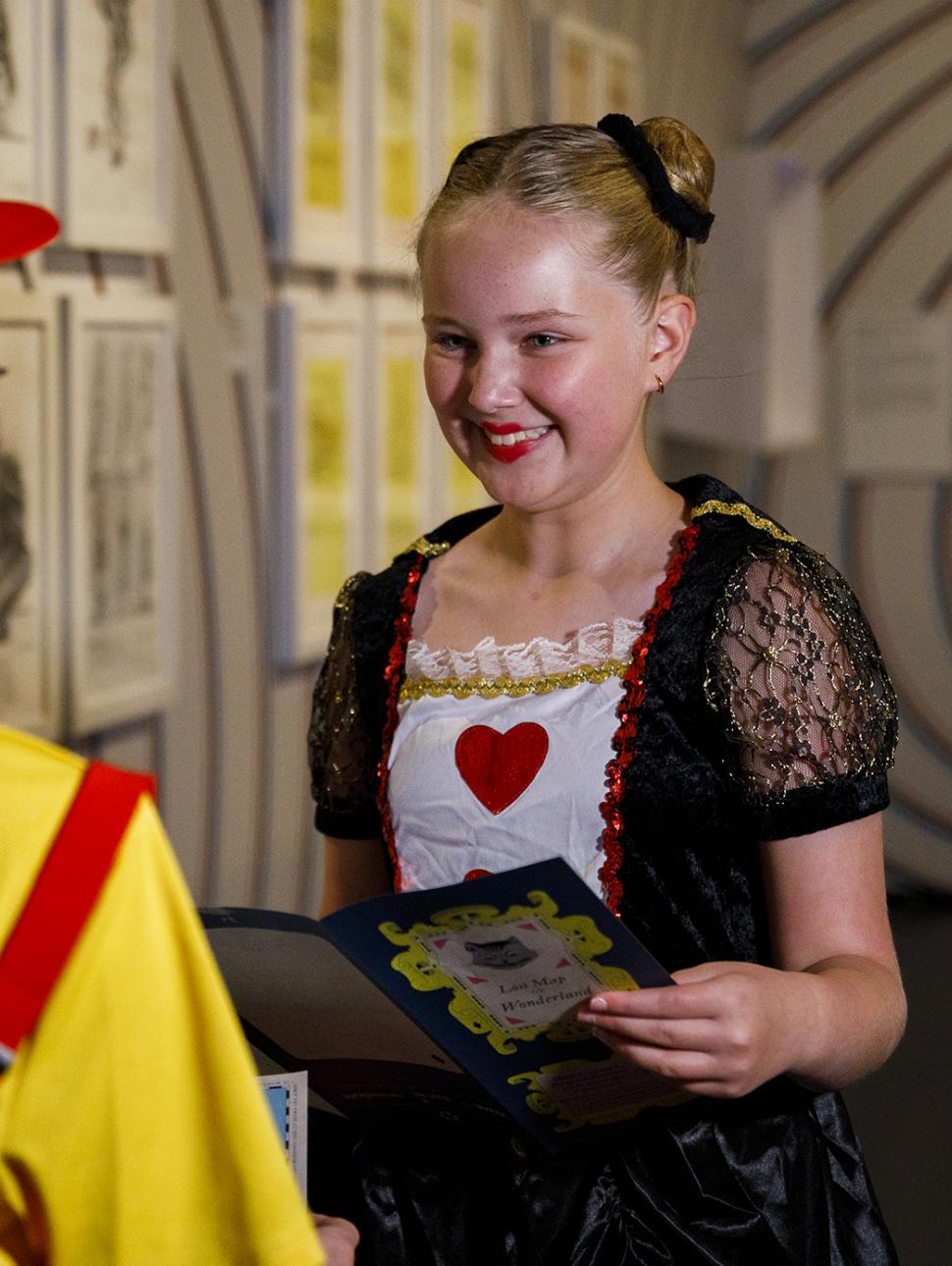 Girl dressed as queen of hearts