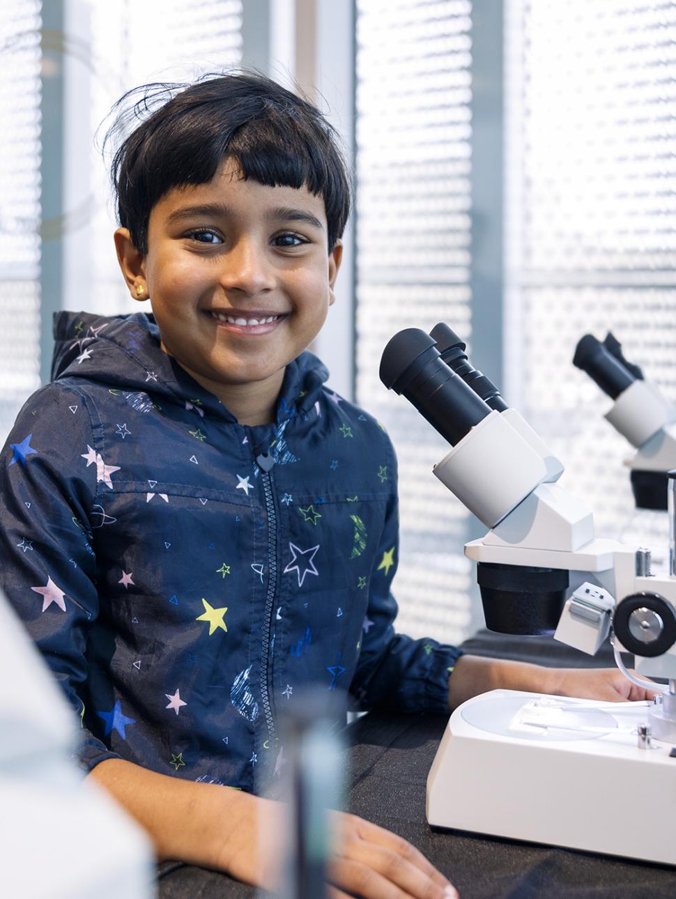 boy at a microscope