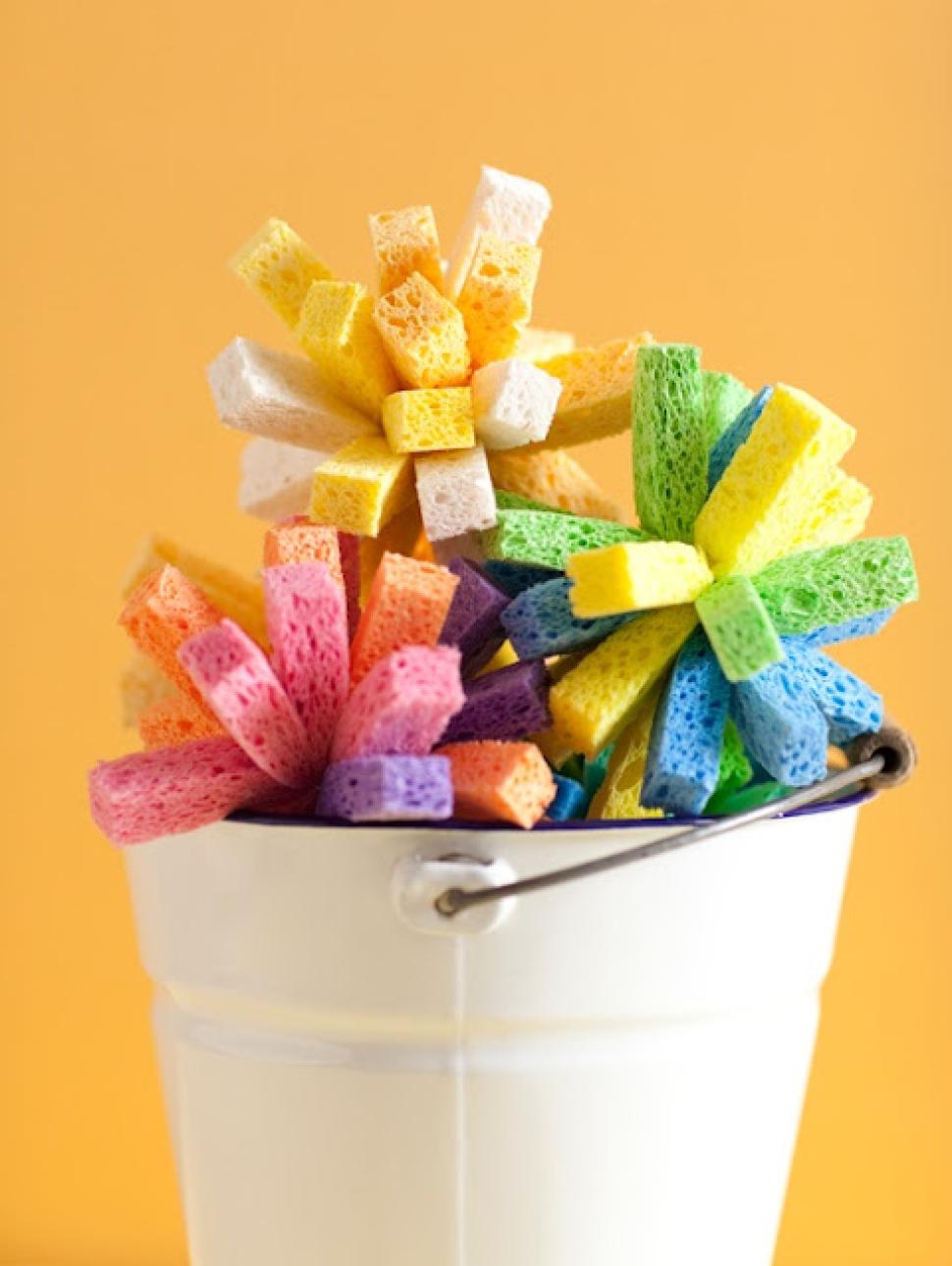 Image of sliced sponges in a white bucket infront of an orange background