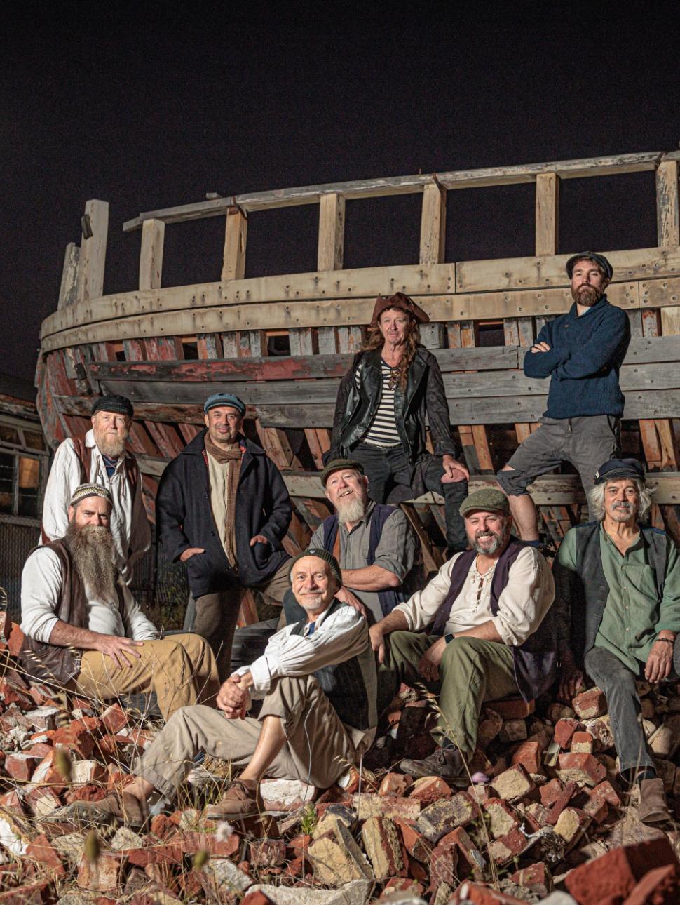 Singing group The Lost Quays pictured in front of an abandoned shipwreck.