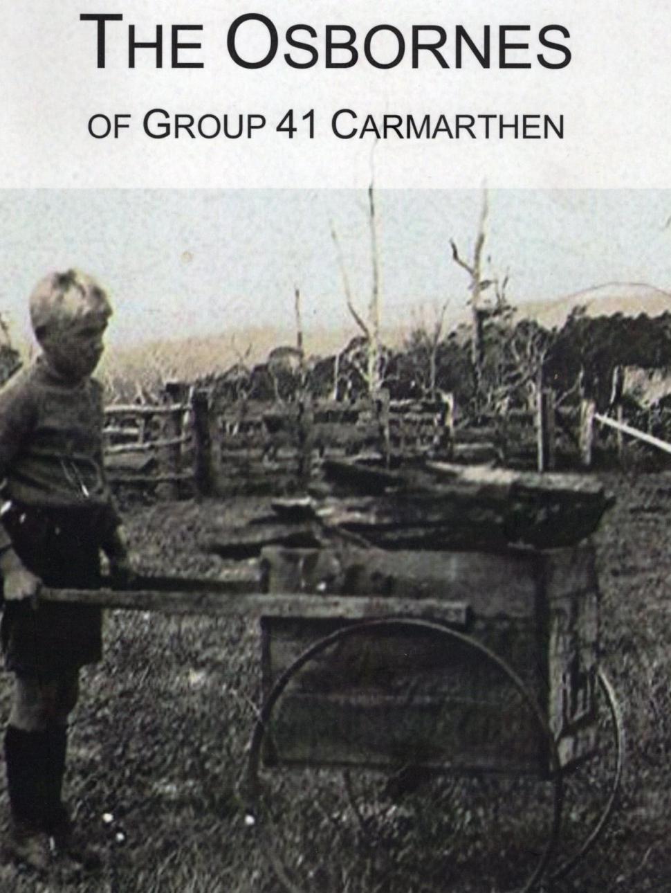 Old image of a child holding a wheel barrow in the middle of the farm.