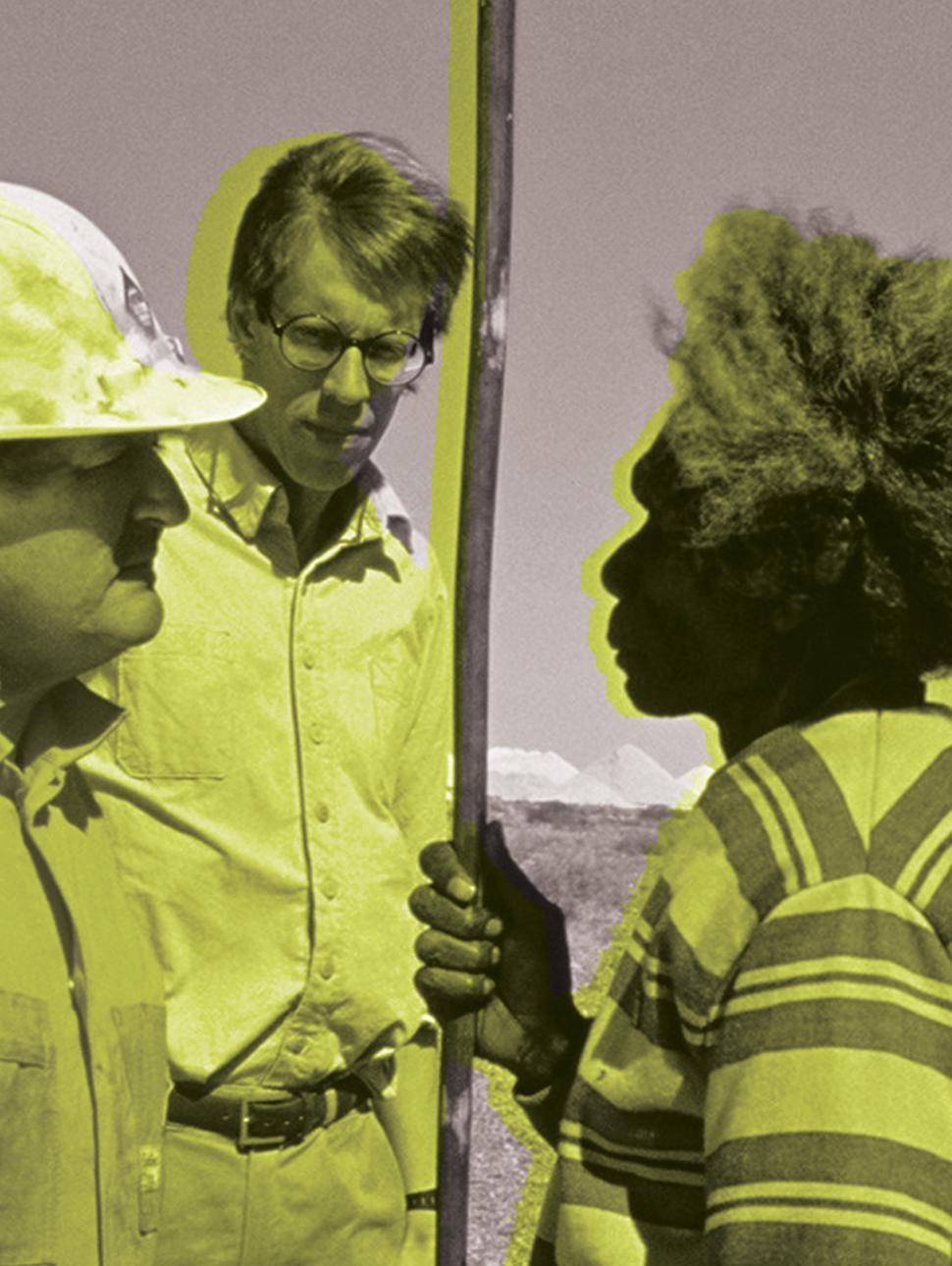 A local Aboriginal community member faces two mining executives on land. The image is in black and white, with neon green washed over the top.