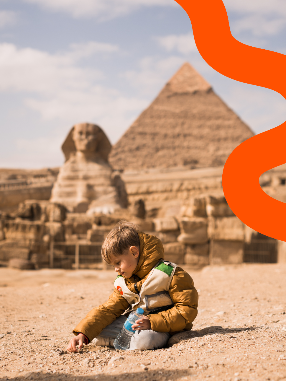 boy plaing on background of Great Sphinx and Chephren's pyramid in Giza, Egypt