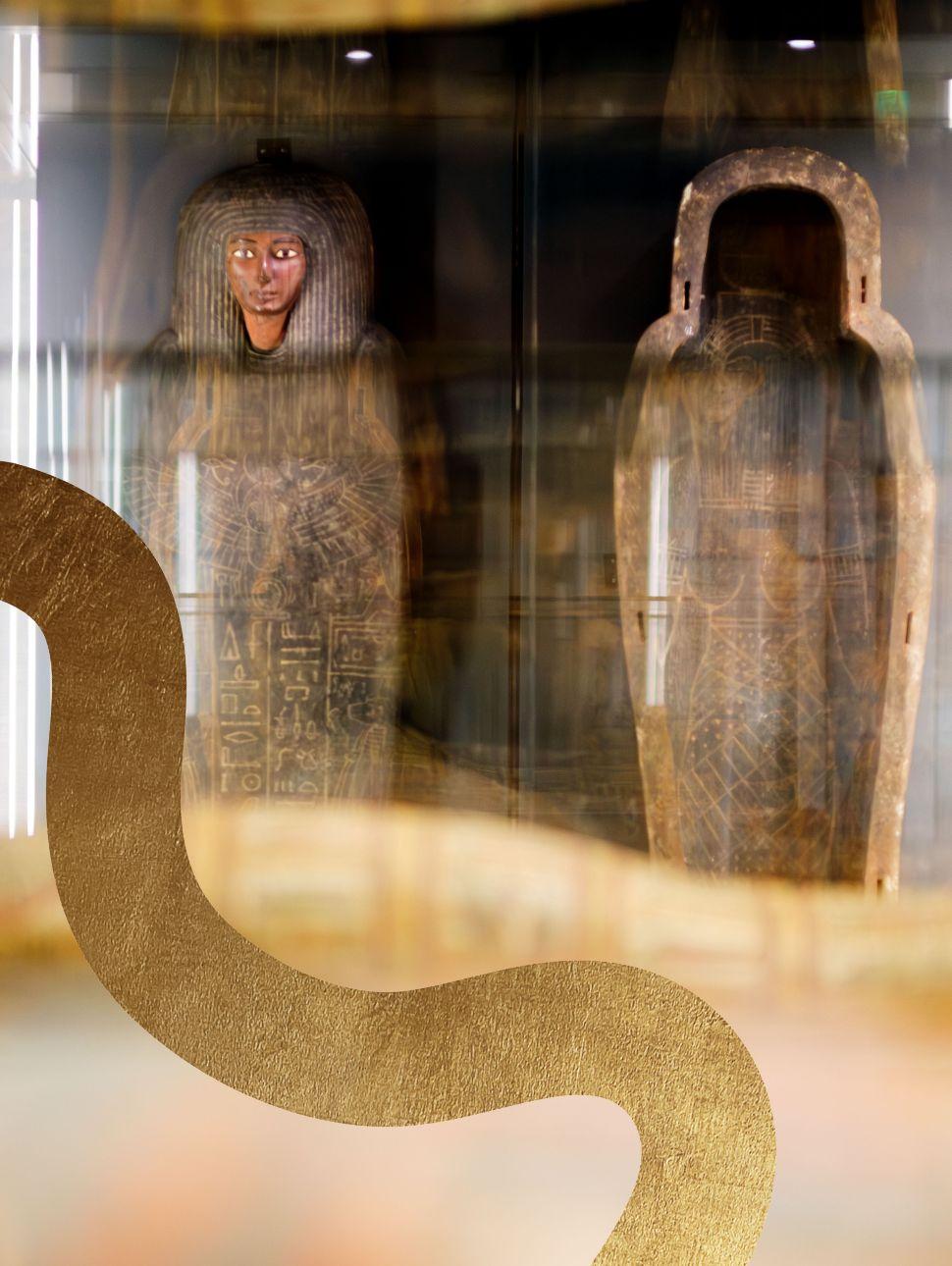 Egypt coffins standing up right in a display cabinet with a gold line texture pattern