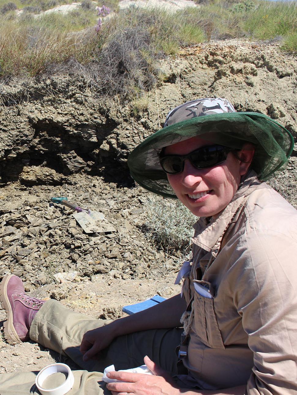 Image of WA Museum scientist Helen Ryan digging for fossils during fieldwork.