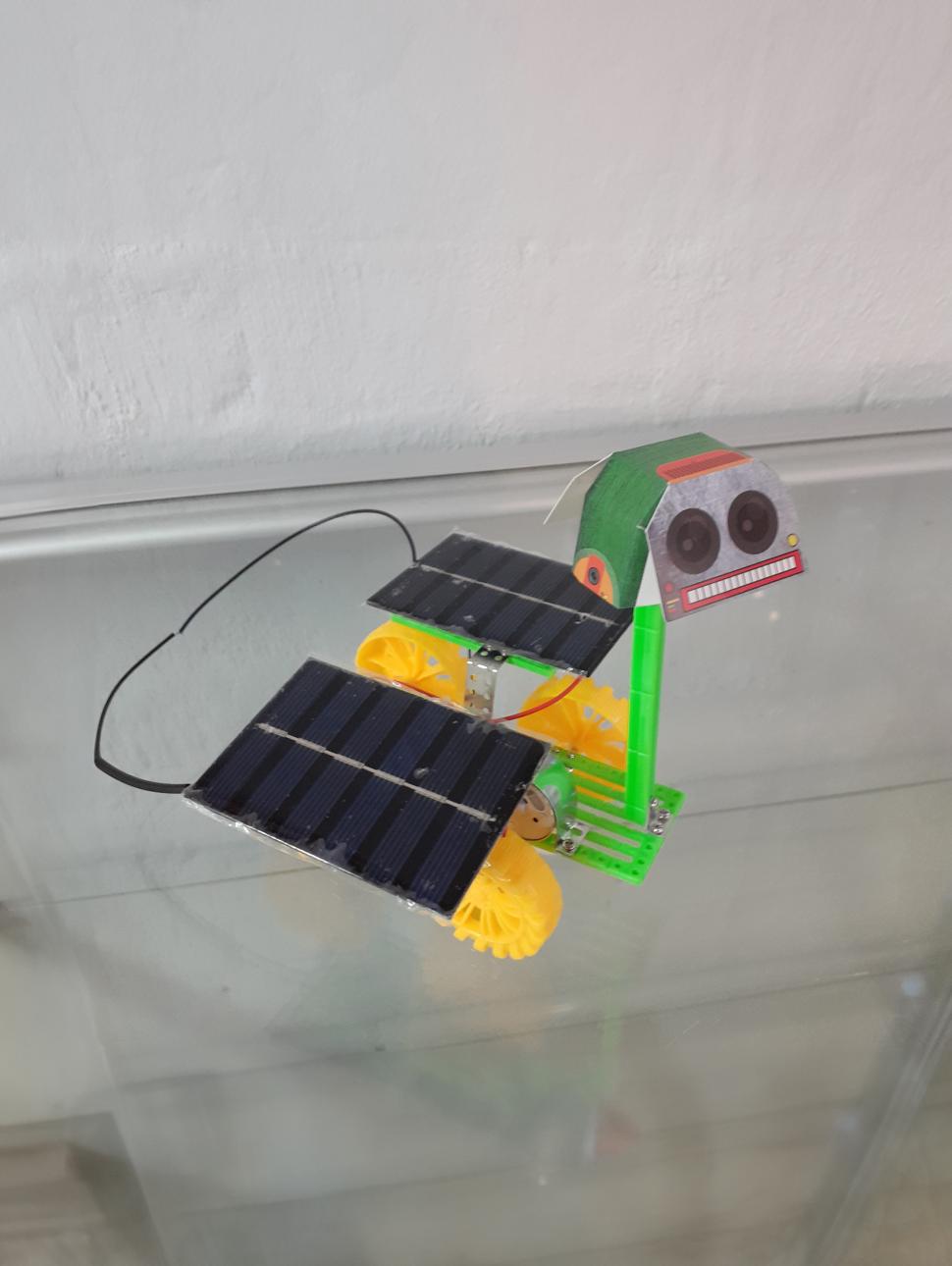 a handmade mini space rover has two small solar panels attached to it