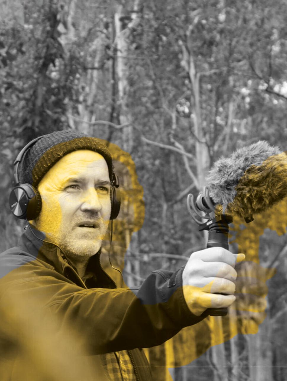 Headshot of Matt Rosner in a forrect holding a microphone