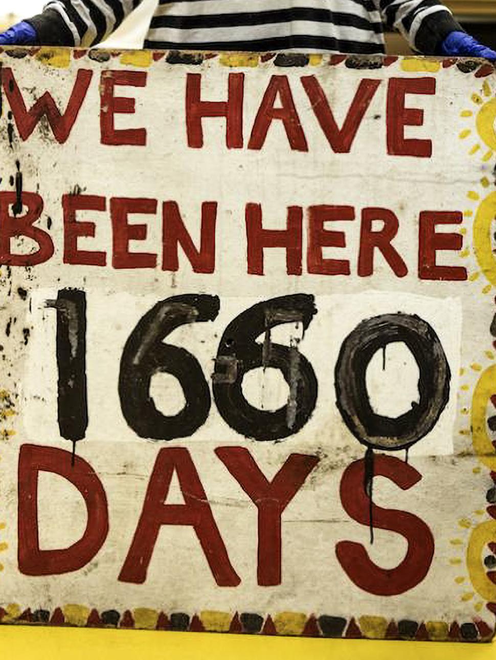 Photograph of sign 'we have been here 1660 days'