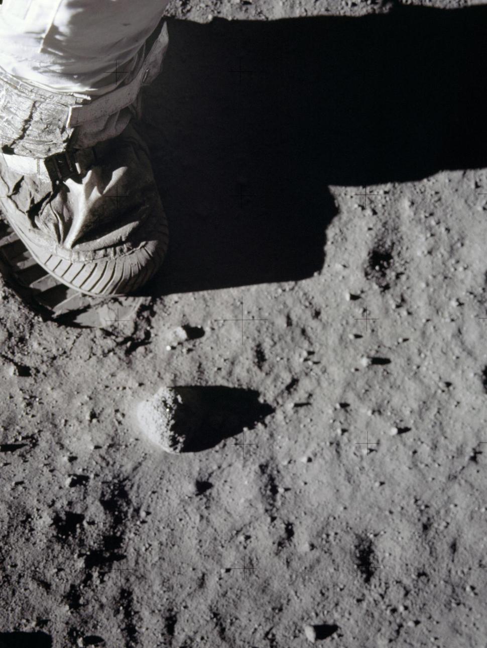 Close-up of astronaut's foot walking on the moon's surface.