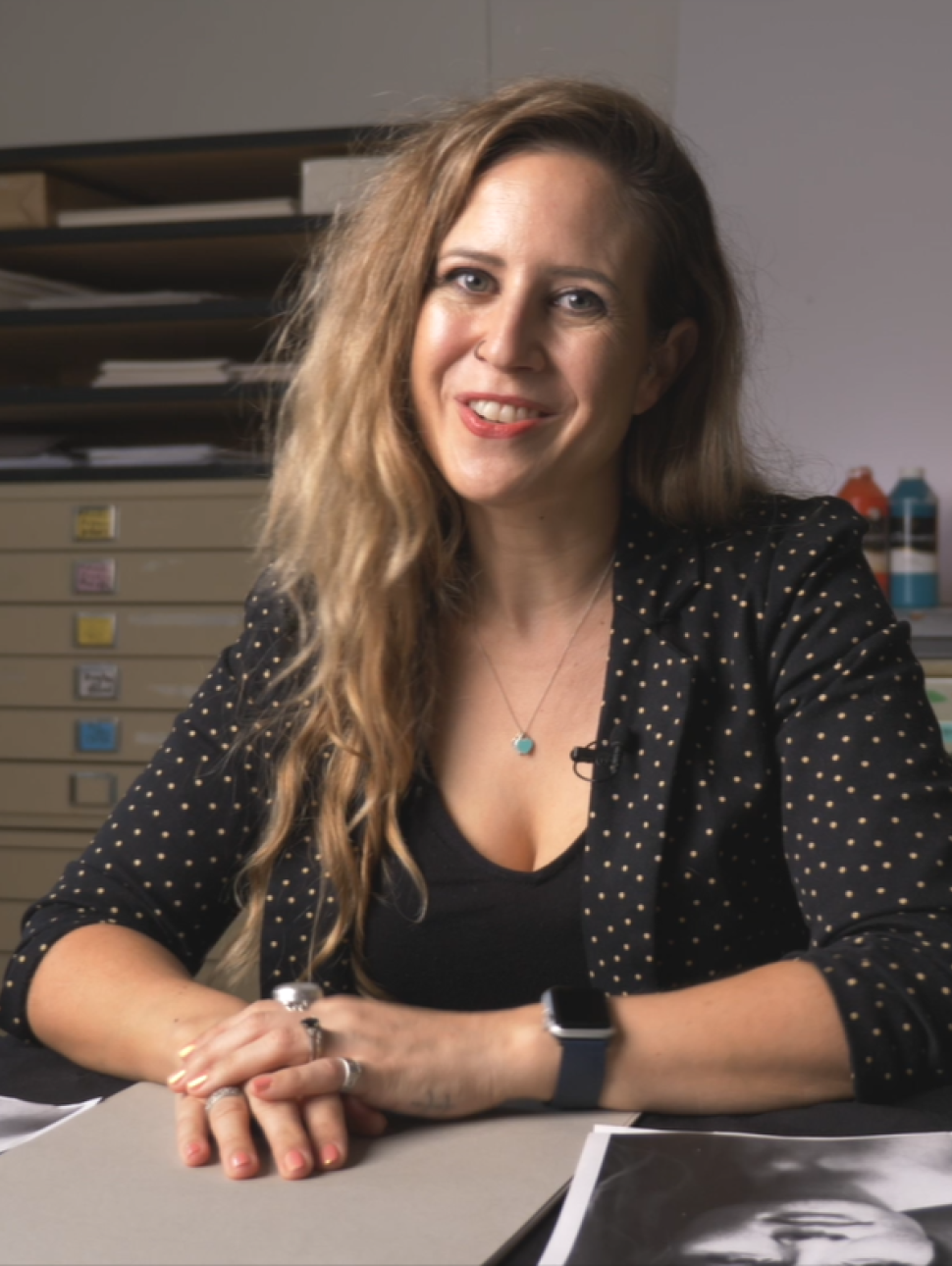 picture of artsit Desiree Crossing sitting at a desk