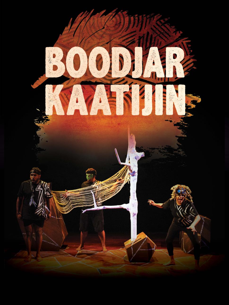 Yirra Yaakin Theatre Company presents Boodjar Kaatijin, a performance for young people about Noongar country and story traditions. This scene features two performers holding a net on the left side from a central, stark white tree, with another performer crouching expressively on the right hand side of the tree.