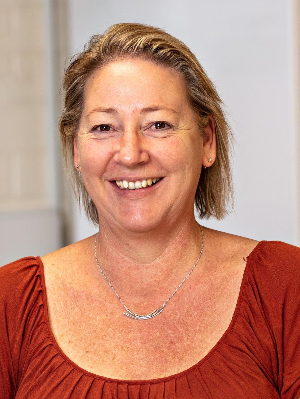 Headshot of woman wearing red top smiling