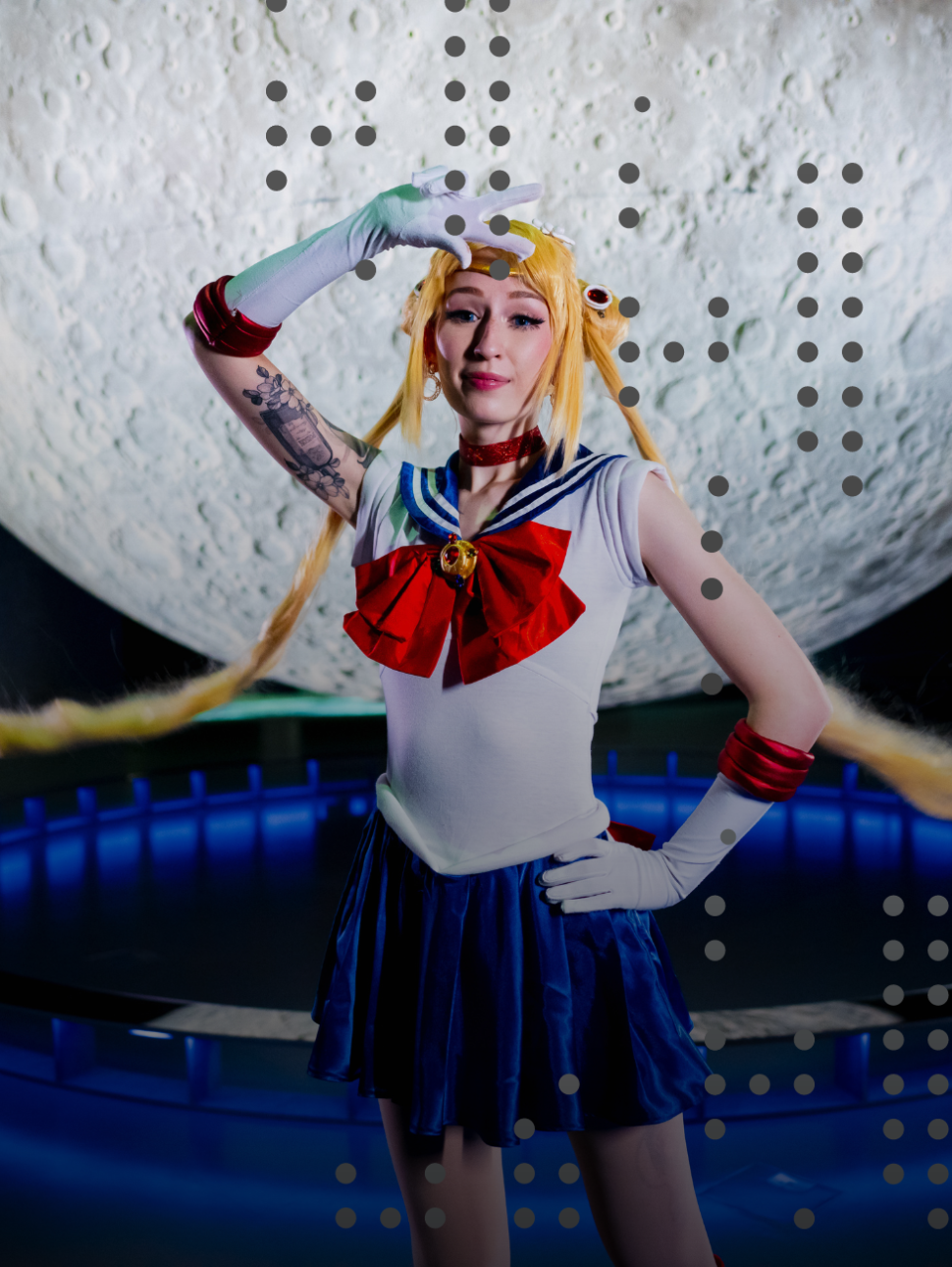 A woman in a sailor outfit posing with a crescent moon in the background.