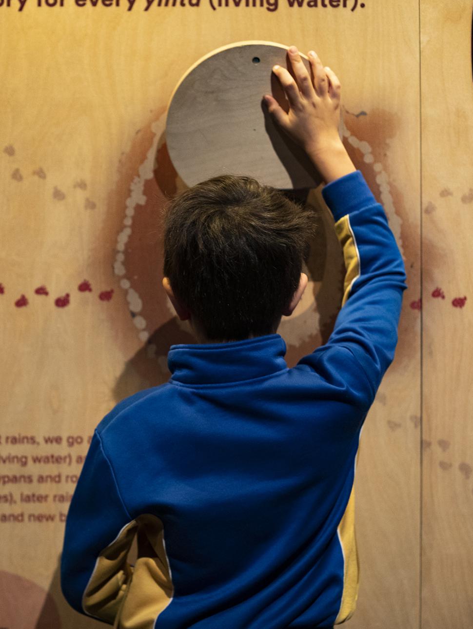 child reading a wall interactive