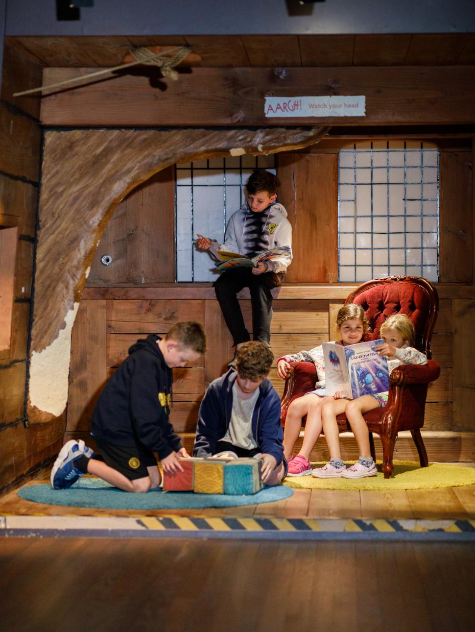 children play and read in an activity corner