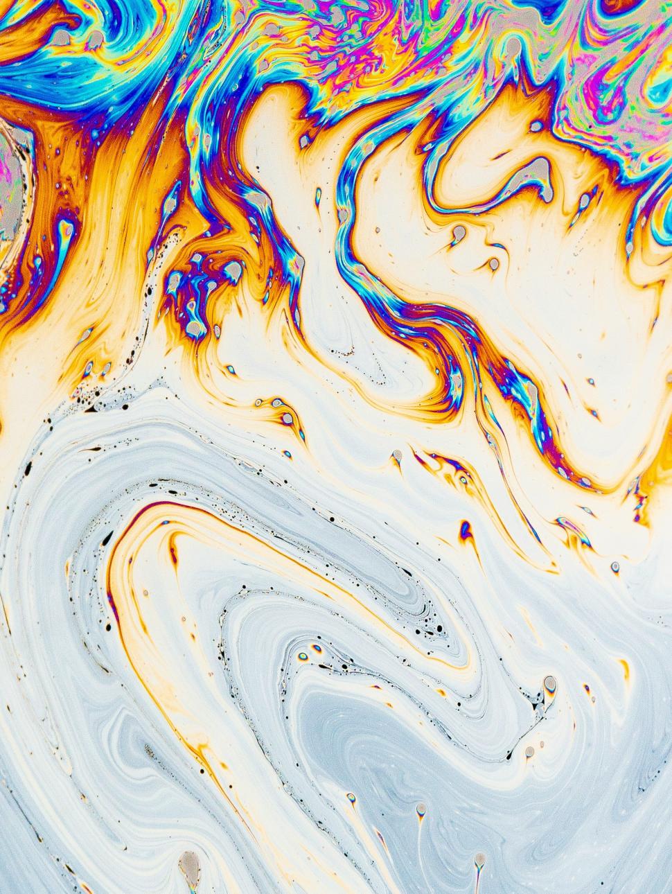 You can see swirls of different colurs, like blue, red, yellow and orange, blending together to make a swirly pattern