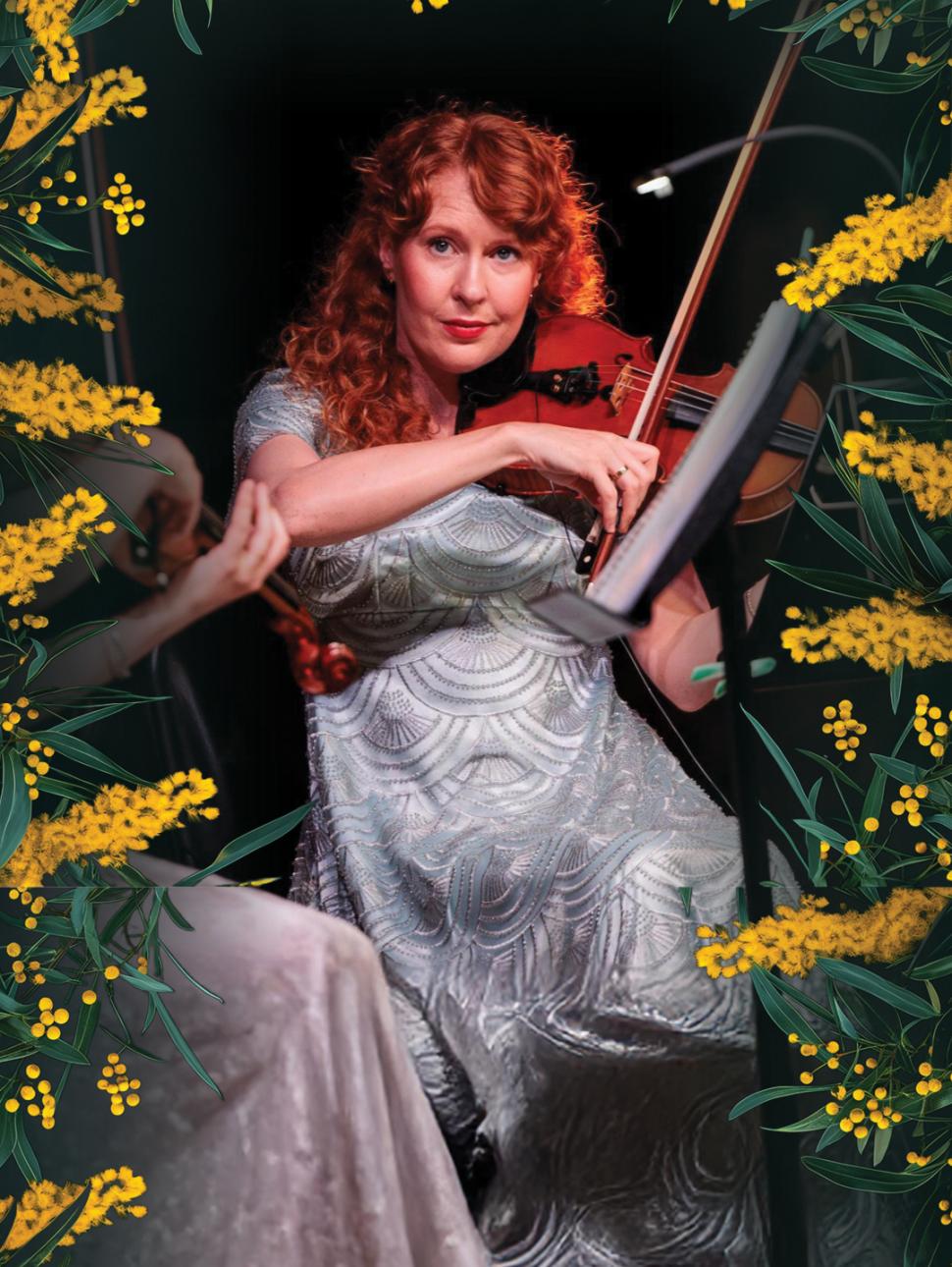a musician playing violin poses with a period costume dress