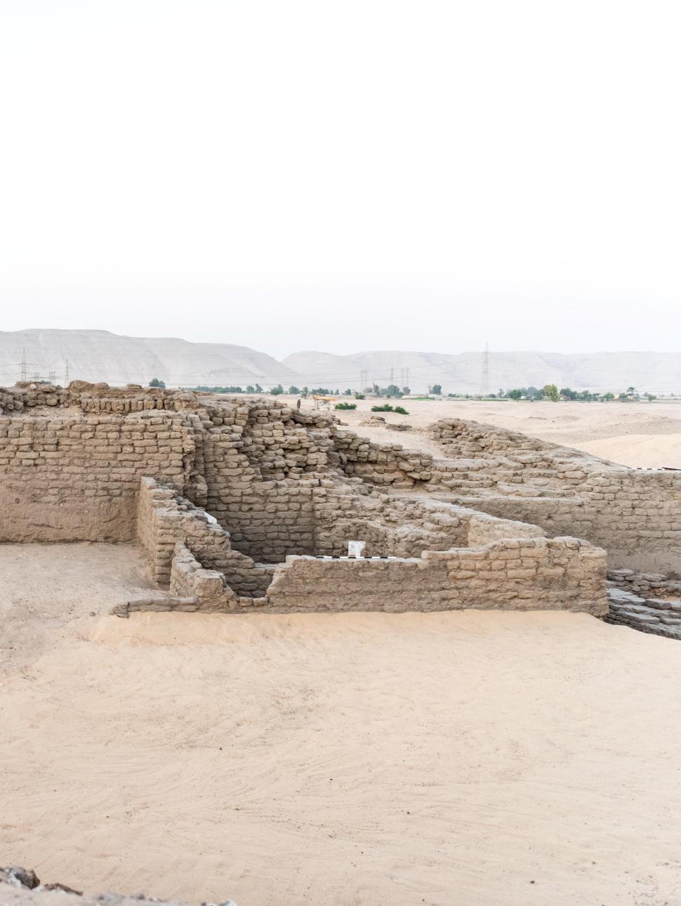 xcavation field in the Egyptian desert with a broken limestone wall