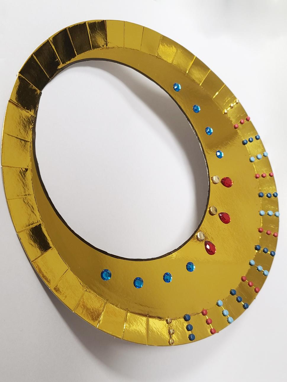 a golden necklace collar made from craft materials 