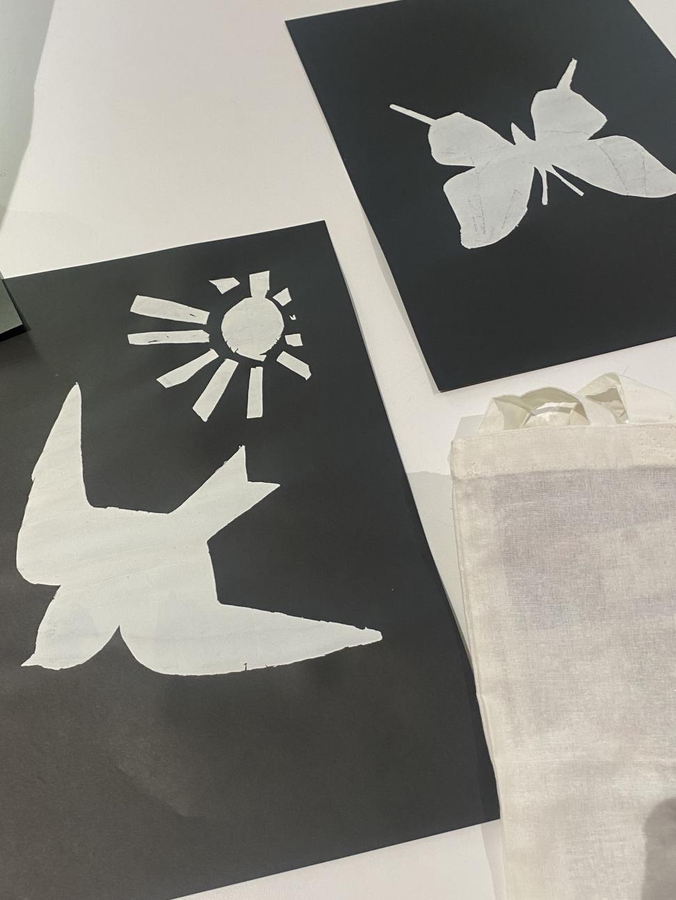 Tow screen printing stencils - a bird and a butterfly - cut out of black card