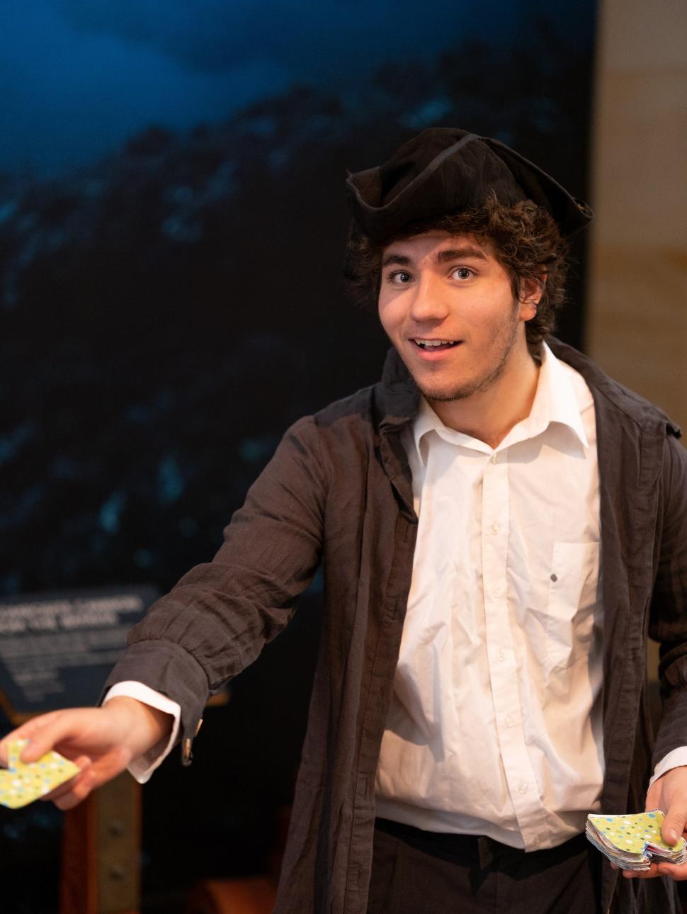a young performer is dressed in historical clothing in the museum