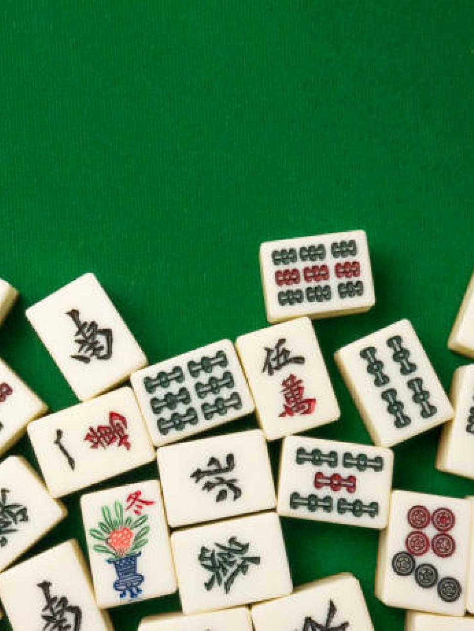 Assortment of Mahjong Tiles on green surface