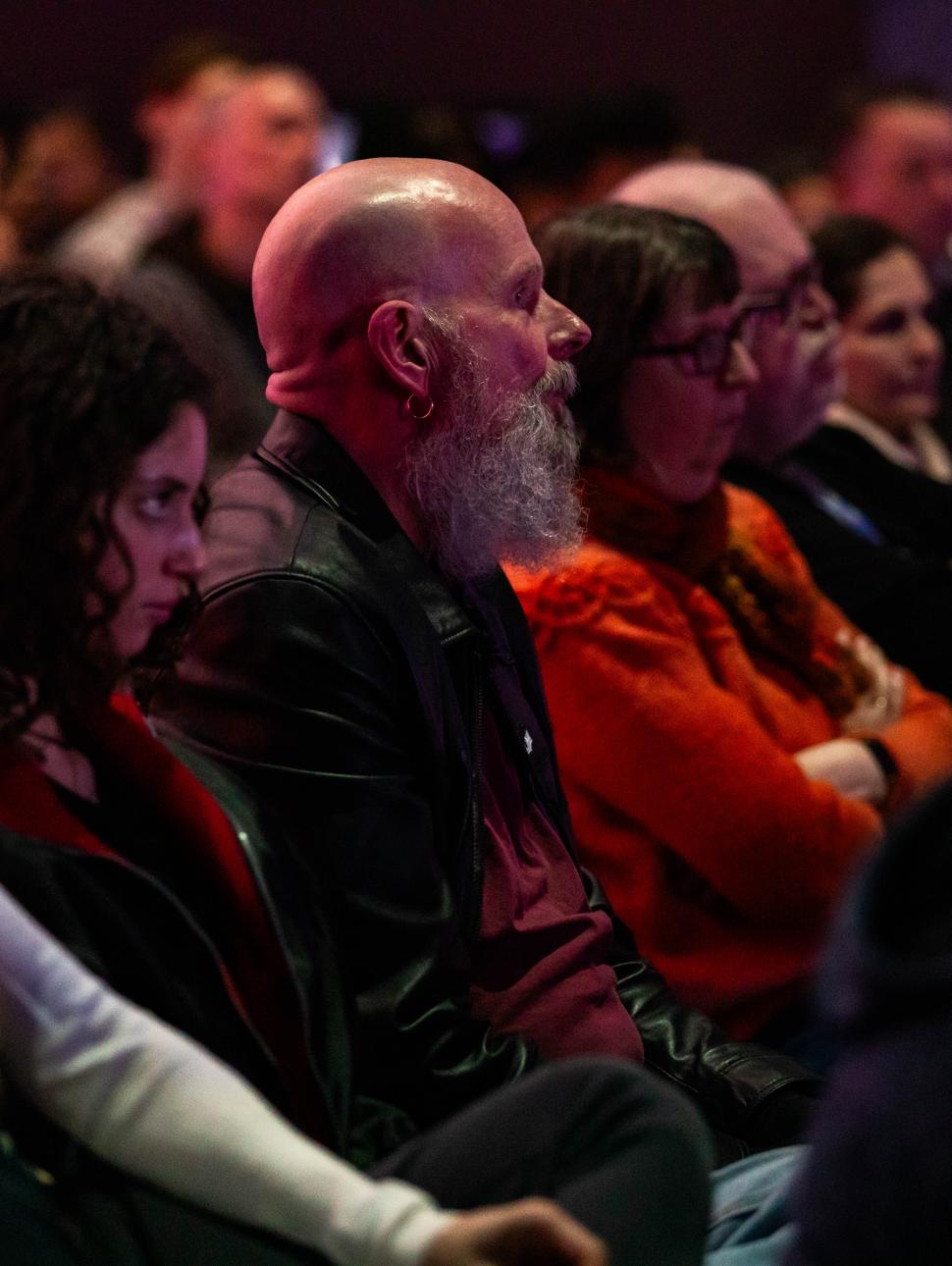 a crowd of people looking and listening