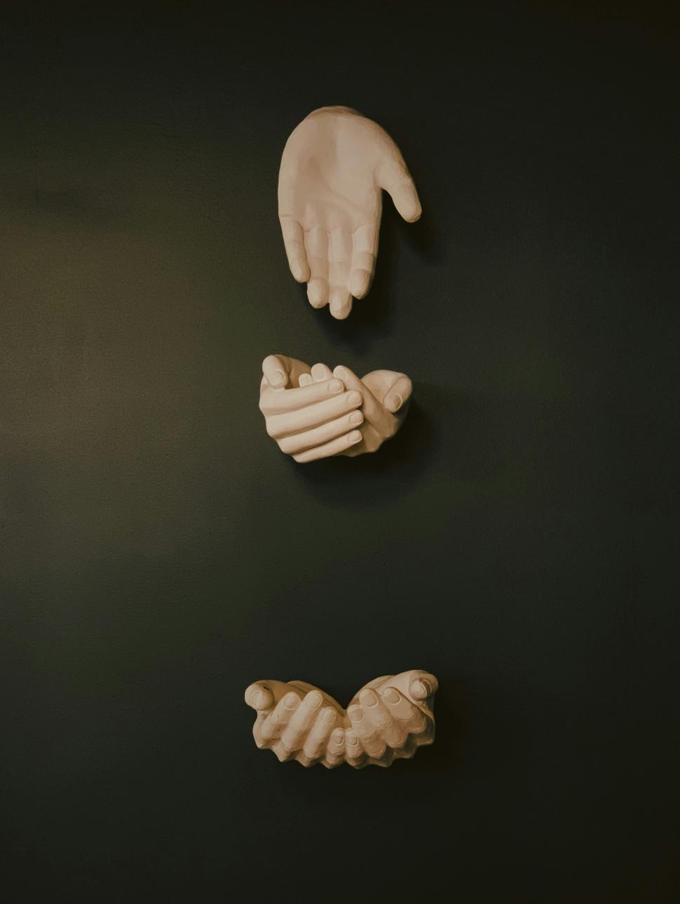 three sets of cast hands arranged in various positions