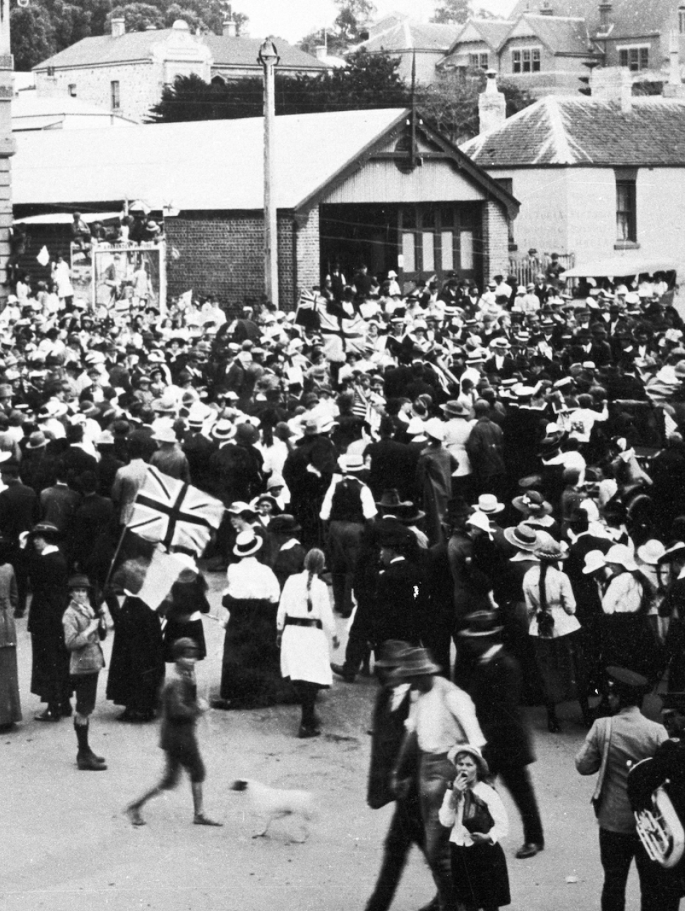 a historical image showing a large crowd gathered outdoors in commemoration