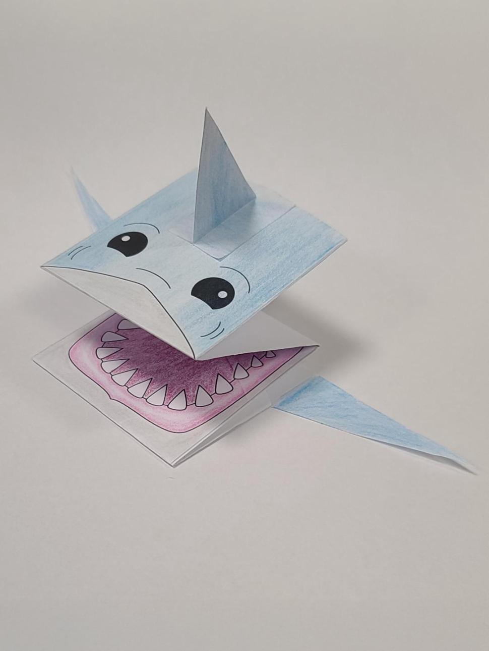 a paper shark folded and coloured in