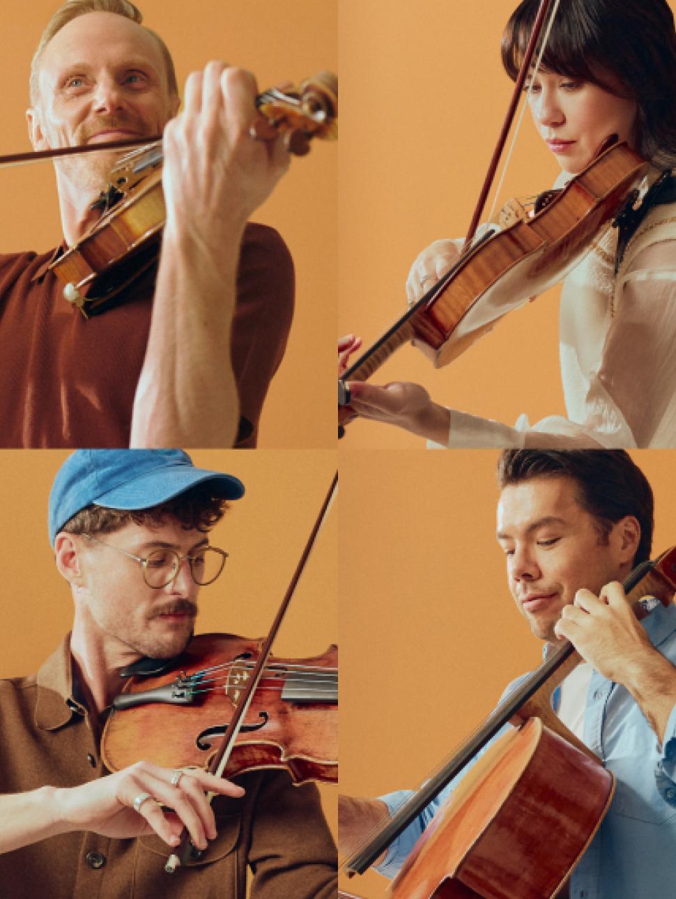 Four musicians playing string instruments against a warm orange background. Three are holding violins and one is playing a cello, with visible bows and strings in mid-performance. 