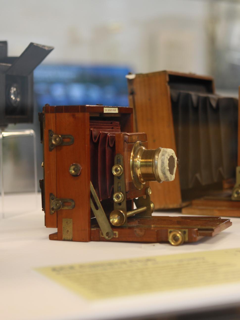 two vintage cameras in a display case 