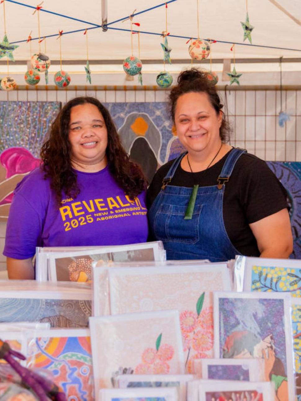 Two revealed artists with their work 