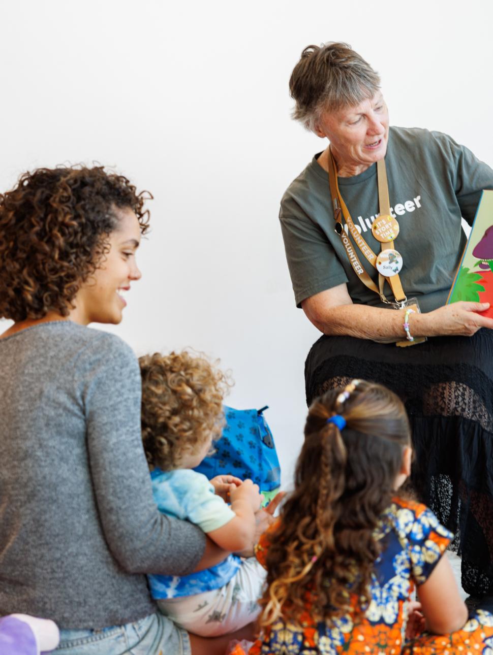 Family listen to a story read by a WA Museum Volunteer