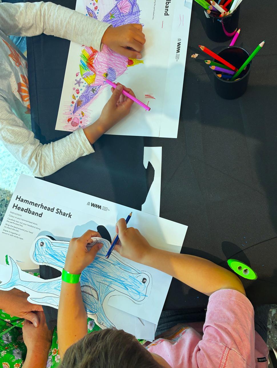 children colouring in marine headbands