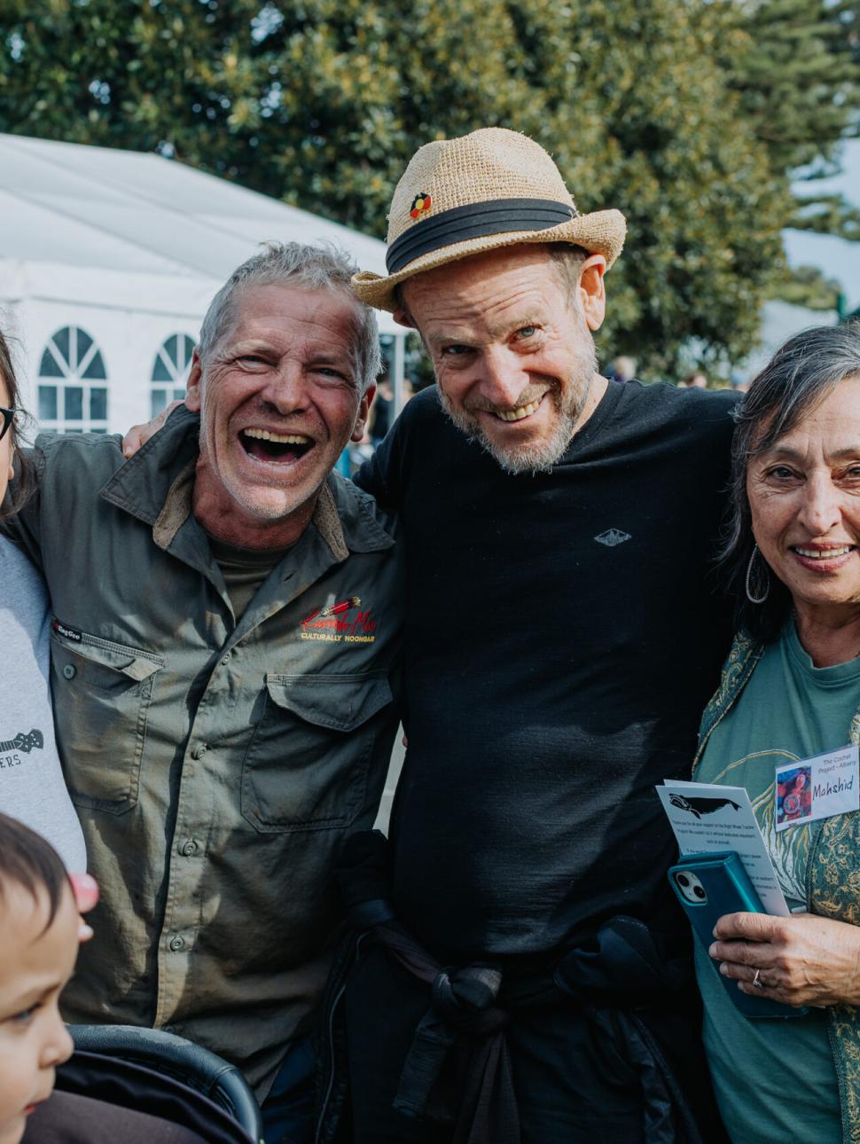 a group of people are all happy and smiling and laughing together outdoors 