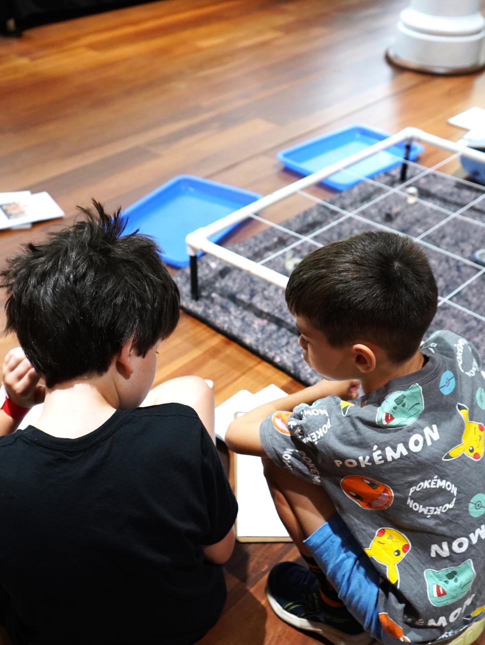 two children discussing a dig activity