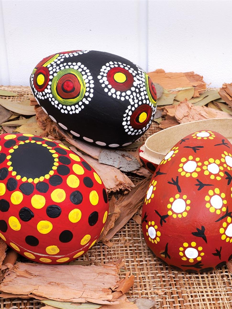 emu eggs decorated in bright colours inspired by indigenous style painting