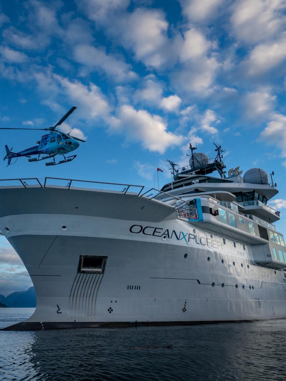 OceanXplorer research vessel on ocean with helicopter landing on deck