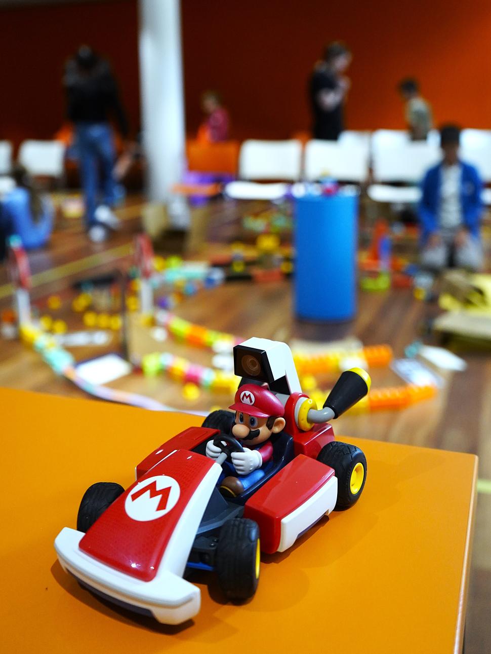 mario kart car with museum session happening behind it in the distance