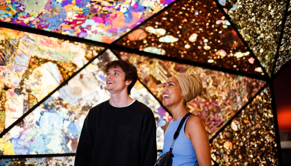 2 people standing in the Origins gallery