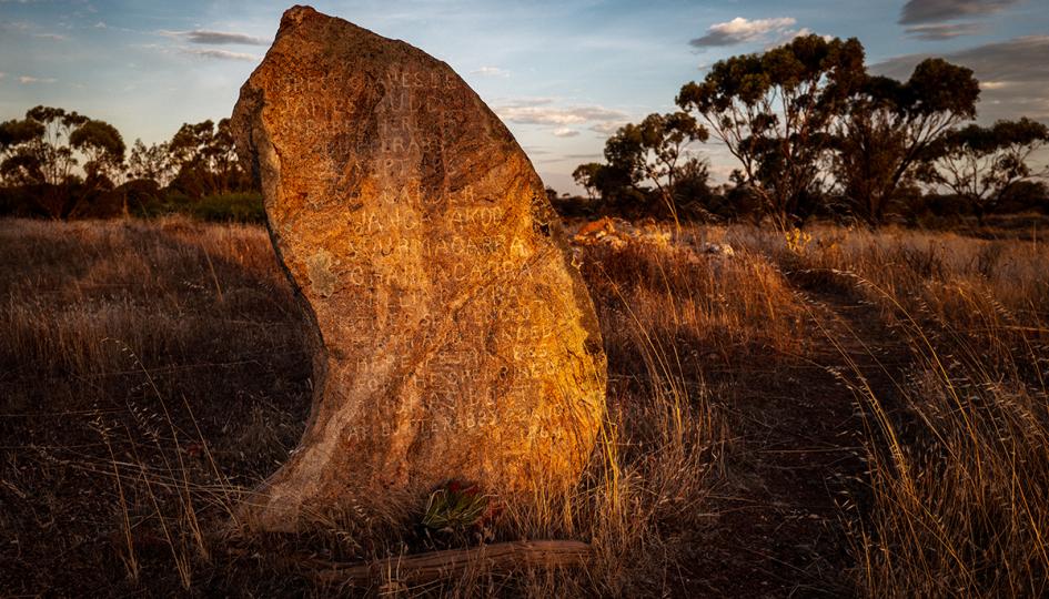 An large engraved rock which acts as an Aboriginal Headstone