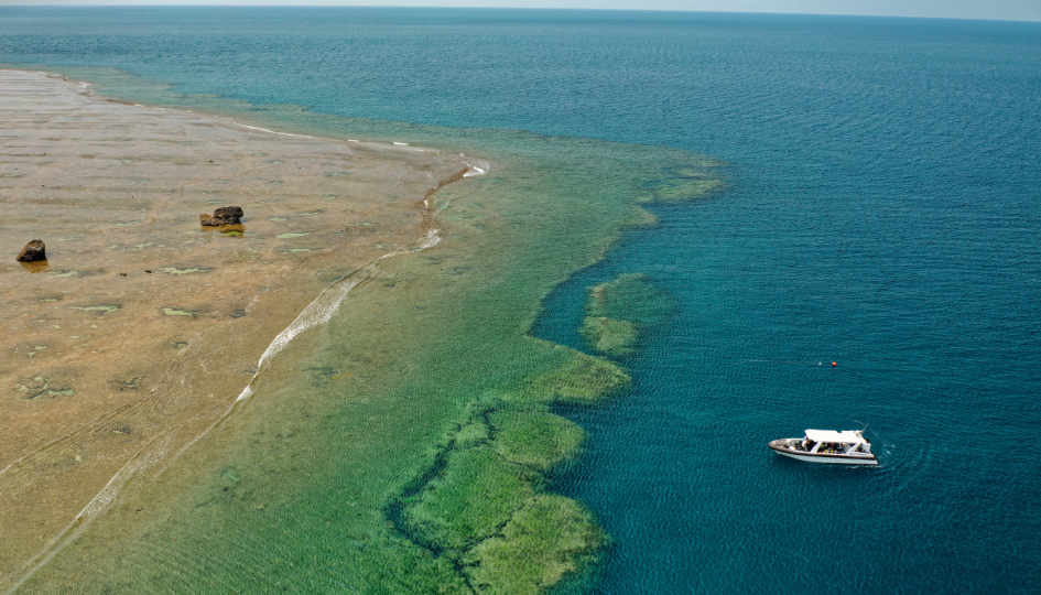 Dissected Reef with boat approaching on the water