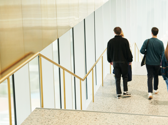 Two people walking down a staircase