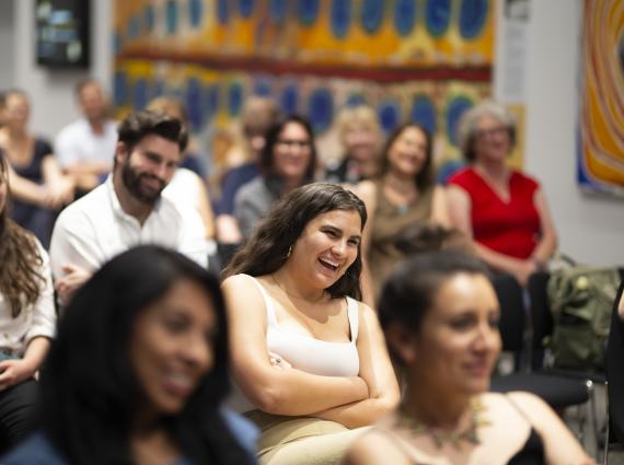 A room full of people listening to a talk