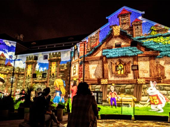 The Old Gaol and the WA Museum Boola Bardip illuminated with imagery from Alice in Wonderland