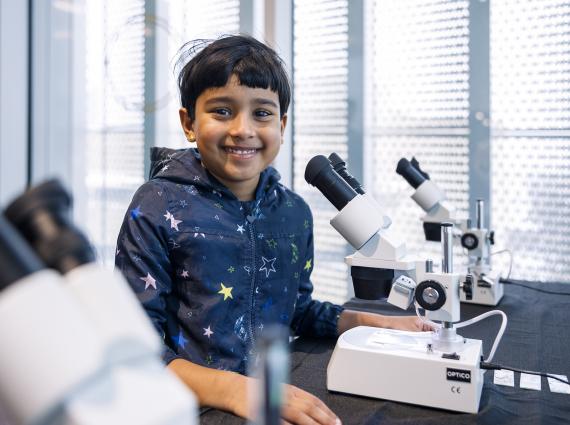 boy at a microscope