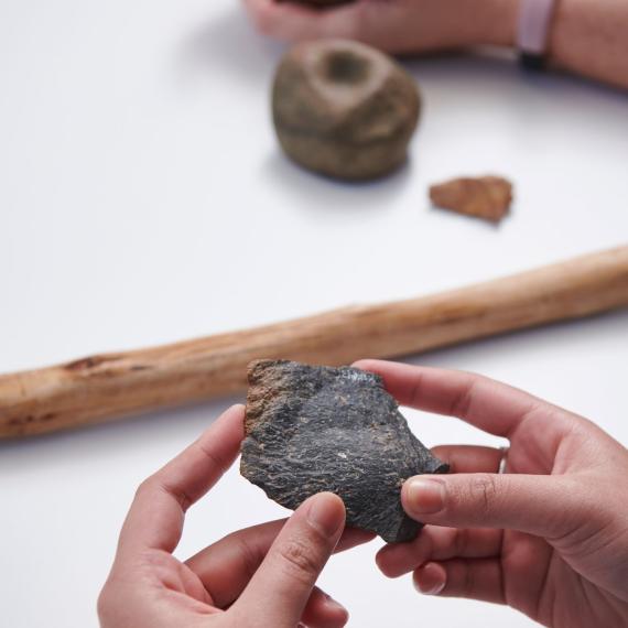 Hands holding stone tools