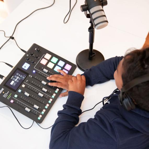 A child recording a podcast